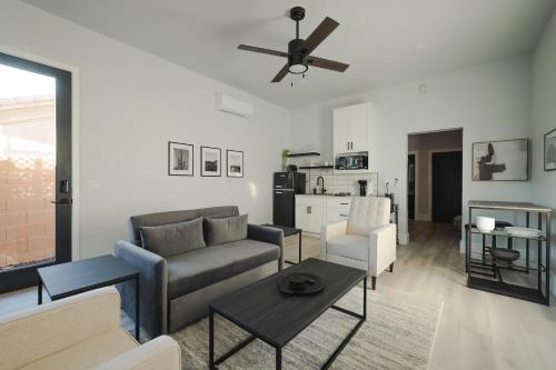 a living room with a couch and a table at Modern Casita,Spa,Pool 10 Min to AZ Athletic Center in Mesa