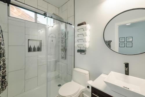 a bathroom with a shower and a toilet and a sink at Modern Casita,Spa,Pool 10 Min to AZ Athletic Center in Mesa