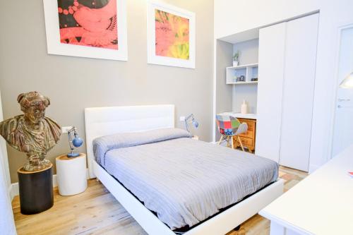 a white bedroom with a bed in a room at Dolcevita Boutique Apartment in Florence