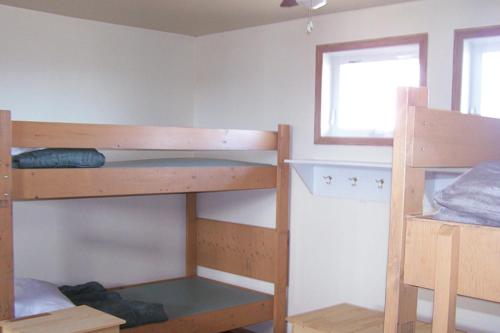 a room with two bunk beds and a window at HI Rossburn 9 Finger Ranch in Rossburn