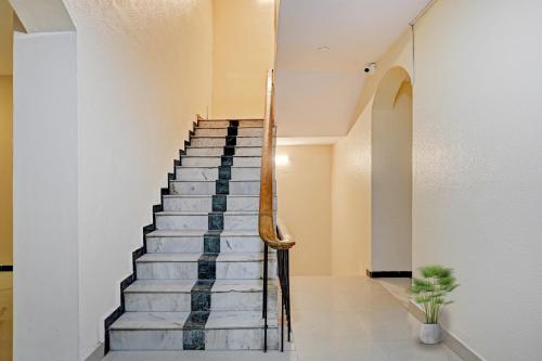 a staircase in a building with a stair case at Super Collection O Planet Grande By Elite Hospitality in Chennai