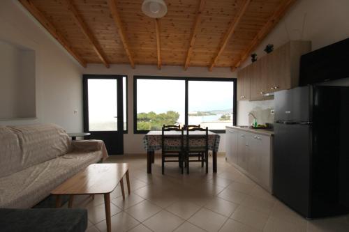 a kitchen and living room with a table and a couch at Vila Bilali in Ksamil
