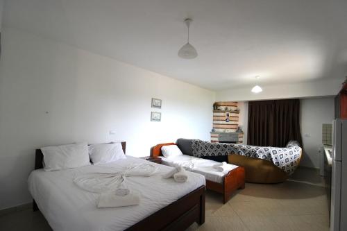 a hotel room with a bed and a couch at Vila Bilali in Ksamil