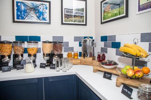 a kitchen with a counter with some food and drinks at Park House Hotel in Shifnal