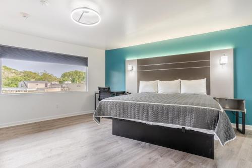 a bedroom with a bed and a large window at Blue Beach Motel Providence North Kingstown in North Kingstown