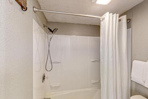 a bathroom with a shower with a shower curtain at Bluewater Resort 816 in Myrtle Beach