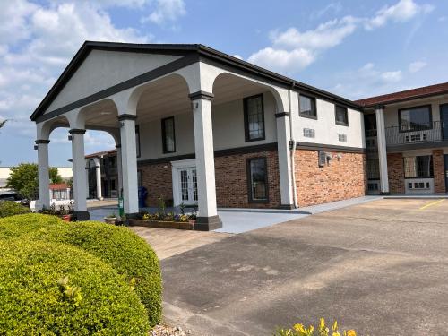 a large brick building with a large pavilion at Americas Best Value Inn Blue Ridge in Blue Ridge