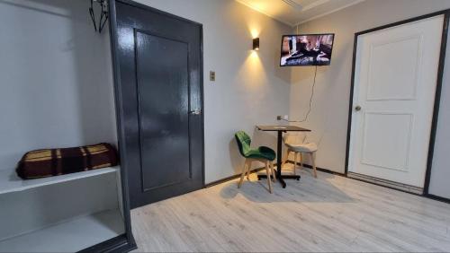 a room with a table and chairs and a door at Hotel Asturias in Viña del Mar