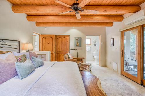 a bedroom with a large bed with a ceiling fan at Casita Tres Hermanos in Santa Fe