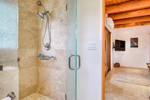 a bathroom with a shower with a glass door at Casita Tres Hermanos in Santa Fe