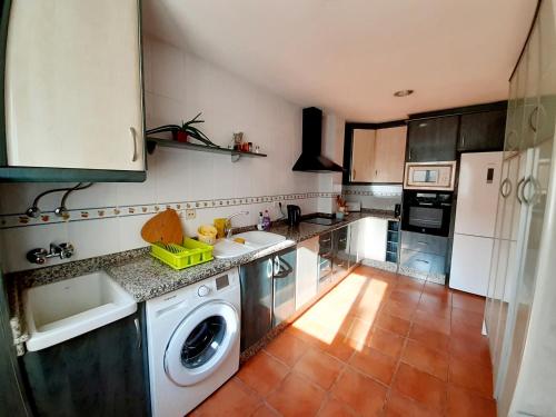 a kitchen with a washer and dryer in it at Apartamento Vernissa in Gandía