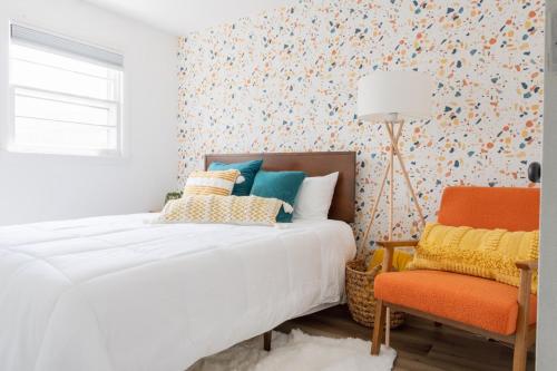 a bedroom with a bed and a chair at Retro Retreat renovated 2BR, desk, no chore list! in Kingston