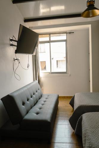 a living room with a couch and a window at Los Ríos in Pereira
