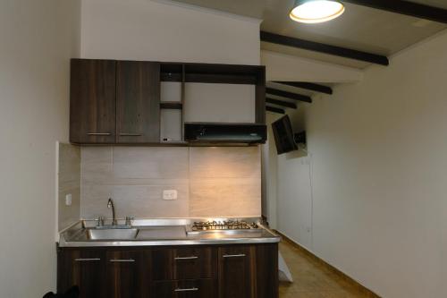 a kitchen with a sink and a counter top at Los Ríos in Pereira