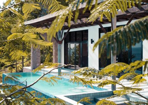 a villa with a swimming pool in the forest at Enclave Villa V3 -Overlooking Pitons & Ocean ! Wow in Soufrière