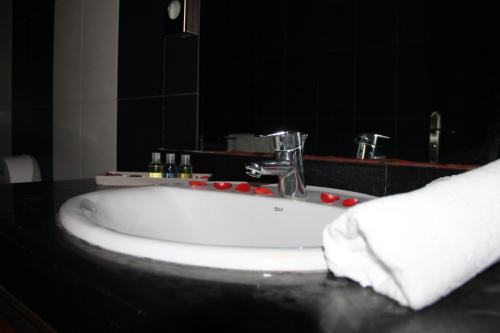 a white sink in a bathroom with a mirror at La Suite Hotel Agadir Adults Only in Agadir