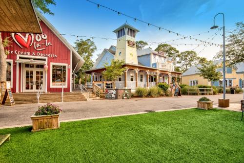 a street in a town with a green lawn at Luau 7010 in Destin