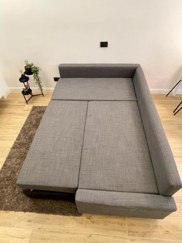 a large sofa bed in a room with a floor at Luxury Downtown - Milan MF Apartments in Milan