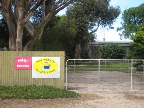 a sign for a dog park with a fence at Dun Workin - Absolute Beachfront in Coobowie