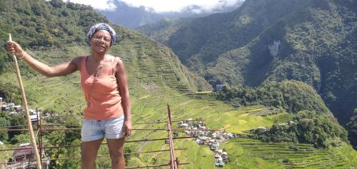 a woman standing on top of a terraced mountain at Las vegas lodge and restaurant in Banaue