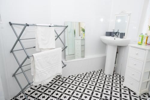 a bathroom with a black and white tiled floor at Shortridge Terrace - 1 in Jesmond