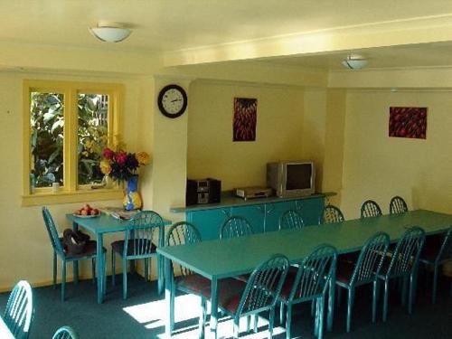 a dining room with a blue table and chairs at Pennys Accommodation in Palmerston North