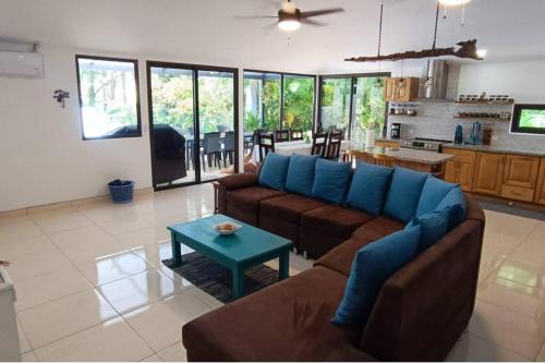 a living room with a couch and a table at Golf Beach House w/ Pool (5 min. walk to beach!) in Tambor