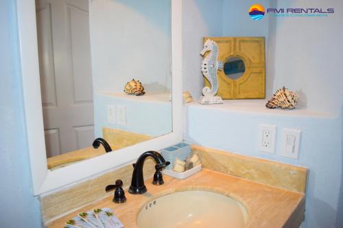 een badkamer met een wastafel en een spiegel bij Marina Pinacate B-101 in Puerto Peñasco