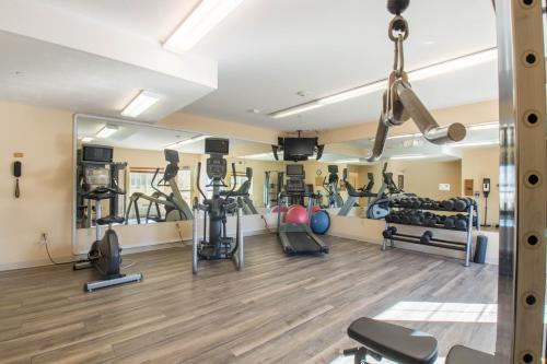 a gym with several treadmills and weights at Western Slope Suites Parachute in Parachute