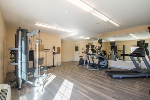 a gym with several treadmills and elliptical machines at Western Slope Suites Parachute in Parachute