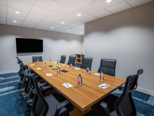 a conference room with a long wooden table and chairs at Staybridge Suites Chicago O'Hare - Rosemont by IHG in Rosemont