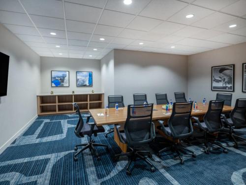 a conference room with a long table and chairs at Staybridge Suites Chicago O'Hare - Rosemont by IHG in Rosemont