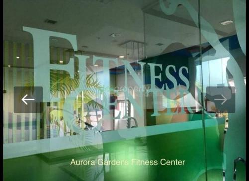 a glass window with the words fitness on it at Modern & Spacious 2BR Condo with Netflix & Pool Acess in San Juan Manila in Manila
