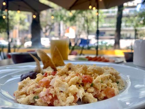 a white plate of food on a table at Casa Anzures S in Mexico City