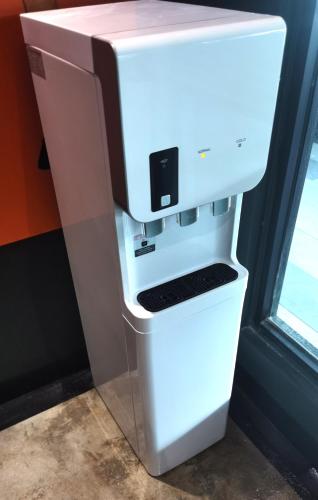 a white coffee maker sitting on top of a refrigerator at 1 Day Car Hotel - BG Perdana in Batu Gajah