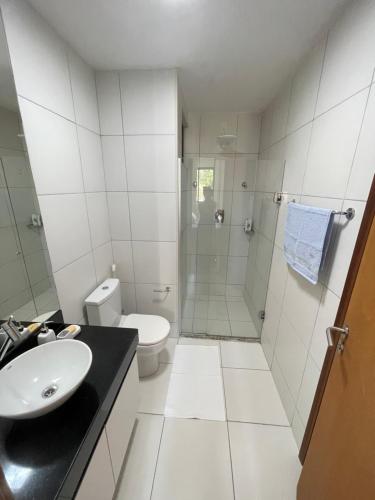 a bathroom with a shower and a sink and a toilet at Iloa Residence Ap 103 K Barra de São Miguel AL in Barra de São Miguel