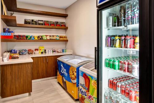 a refrigerator filled with lots of drinks at Holiday Inn Express Hotel and Suites Katy by IHG in Katy