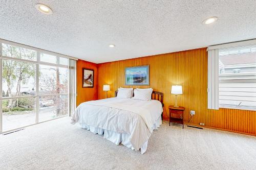 a bedroom with a bed and a large window at The Garden Suite on M Street in Anchorage