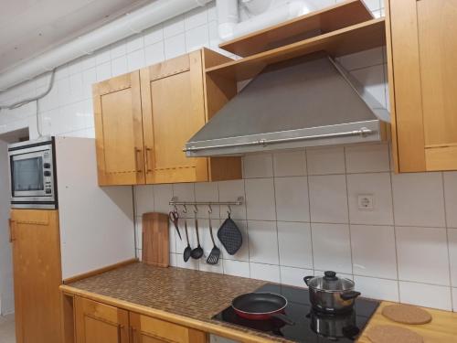 a kitchen with wooden cabinets and a stove top oven at Bed&Blues in Vilnius