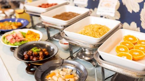 a group of bowls of food on a table at Hotel Dorf Shizuoka in Shizuoka