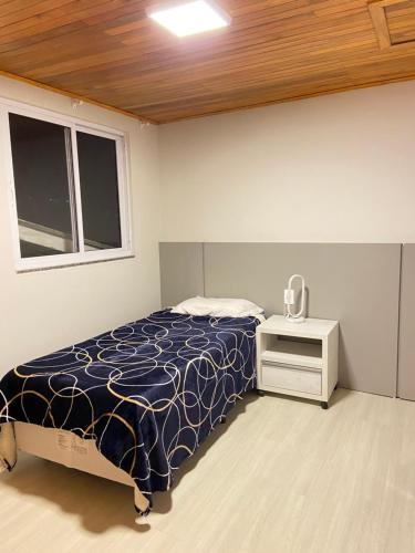 Säng eller sängar i ett rum på Loft na Serra Catarinense