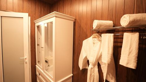 a bathroom with white towels and a mirror at Prive by Whiteflower in Vagator