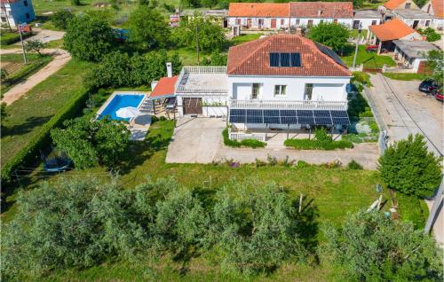 an aerial view of a house with a swimming pool at Holiday Home Skabrnja 79 With Outdoor Swimmingpool in Galovac