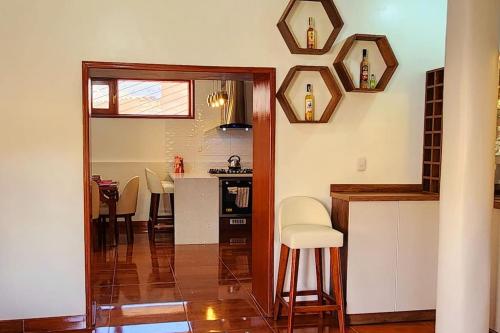 a kitchen and living room with a table and chairs at El Rey Lobo Casa de Campo Valle Sagrado in Urubamba