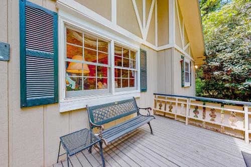 a bench sitting on the front porch of a house at Cobb House in Highlands