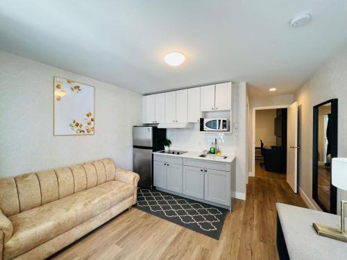 a living room with a couch and a kitchen at Hotel Civilia Lakeside by Civilia Golf Retreat in Clearwater