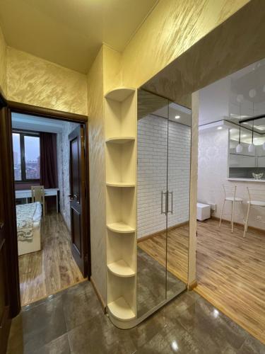 a room with a glass shower and a bedroom at Apartment in Tumanyan street in Yerevan