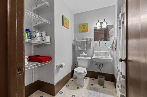 a small bathroom with a toilet and a sink at Perfect Blend of Convenience & Comfort Syracuse NY in Syracuse