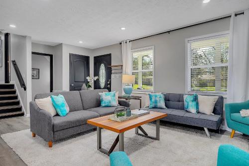 a living room with two couches and a table at GoodKarma Rentals Spacious and Comfy Abode in Austell in Austell