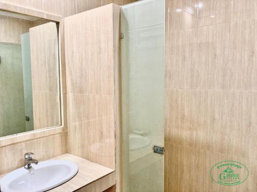 a bathroom with a sink and a shower at Garden Village Guesthouse & Pool Bar in Siem Reap